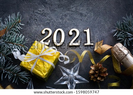 HAPPY NEW YEAR 2021 BACKGROUND OVER DARK STONE TABLE WITH HOLIDAYS DECORATIONS