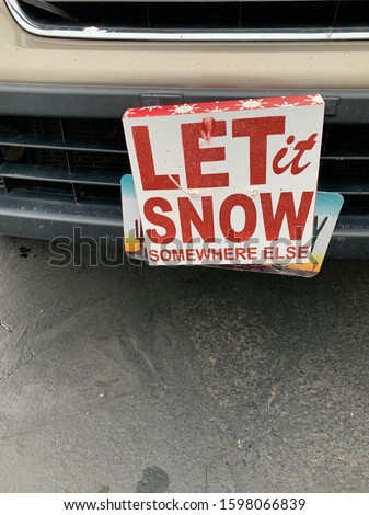 Sign on vehicle that reads:  Let it Snow Somewhere Else