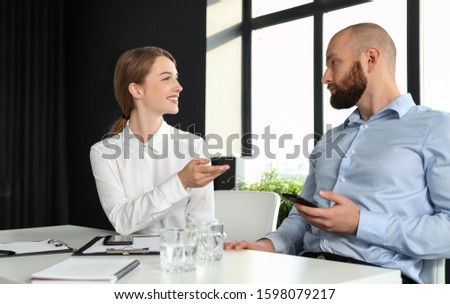 Business people talking at white table in conference room