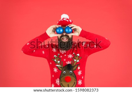 Winter decorations. New year. Hipster cheerful bearded man wear winter sweater and hat hold balls. Christmas party. Winter holidays. Avoid overwhelming anxiety when faced with holiday stressors.