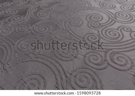 Close up of white fabric with symmetrical patterns and textile texture background