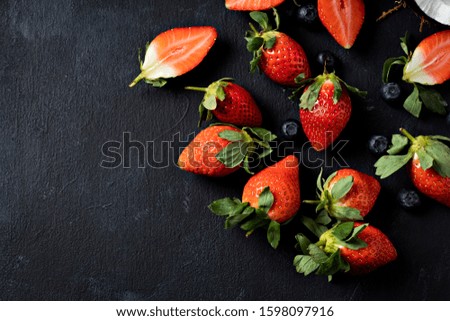 fresh strawberry, top view on a black background. - Image