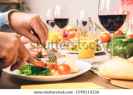 Closeup picture of hands, fingers, many tasty and clolorful food