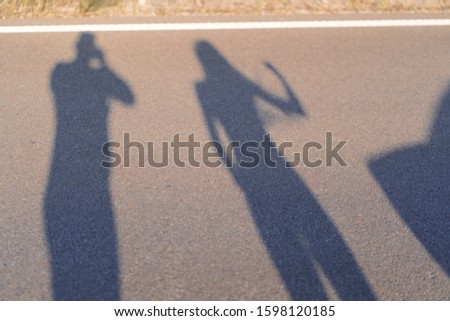 Shadows and silhouettes of people at a city during sunset. Shadows of the family while thay was running together in the evening.