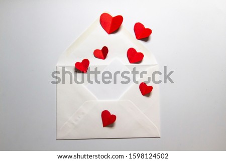 Envelope with a letter and flying hearts. A lover letter. A composition with hearts and letter. A message about love