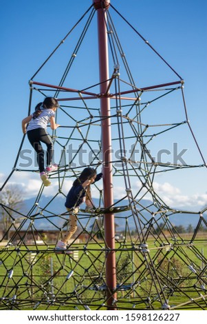 The image of the playing field in the park has many games that are wanted by the children, safe and beautiful, colorful, the ground is made of green grass on clear days.
