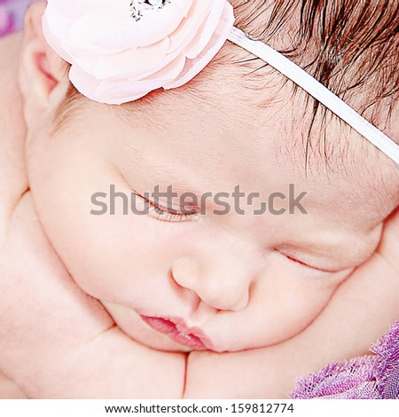 Beautiful Newborn Baby Girl Posing for Camera in Studio