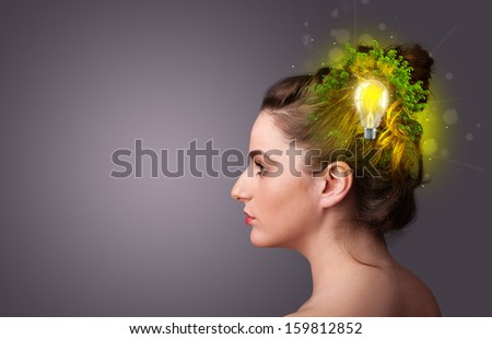 Young mind thinking of green eco energy with lightbulb on grungy background