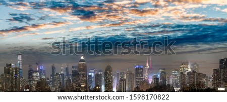 Panoramic night skyline of Midtown Manhattan at winter sunset, New York City.