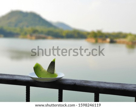 Delicious green  melon at the balcony with mountain and lake view at summer time of Thailand,  Asia by selective focus. 