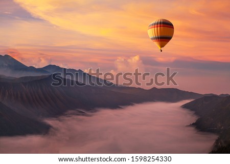 travel on hot air balloon, beautiful inspirational landscape with sunrise colorful sky Royalty-Free Stock Photo #1598254330