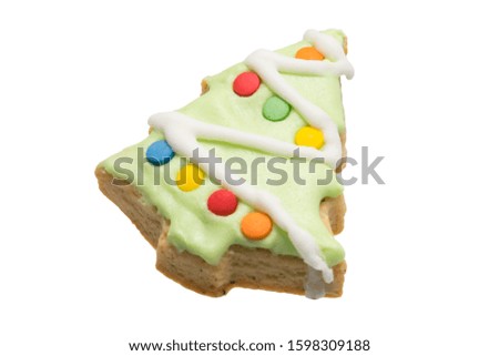 gingerbread cookie in the form of a decorated green Christmas tree isolated on a white background