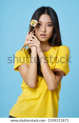 Woman Asian appearance sushi rolls yellow tank top