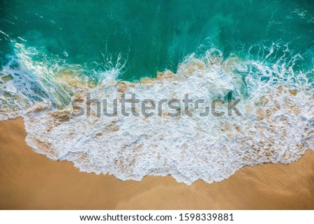 Aerial view of beach and waves.Turquoise water and pattern of waves from top view.