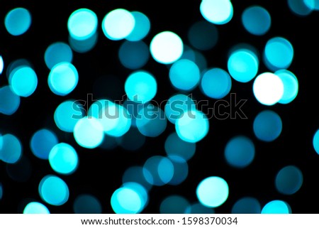 Blurred abstract blue glitter texture, defocused christmas lights. Holiday christmas concept. 