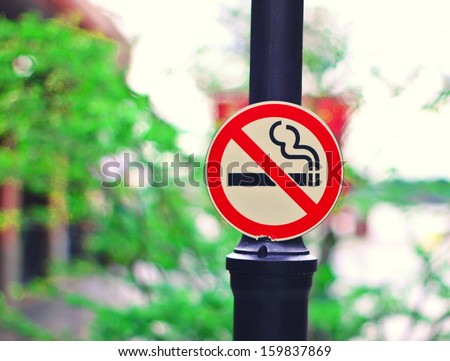 No smoking sign pole in park