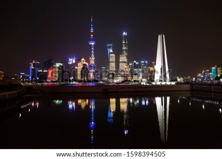 Panoramic picture of skyscrapers of Pudong district from the Bund in Shanghai at night in winter