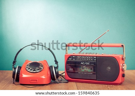 Retro old radio recorder, headphones and red telephone concept