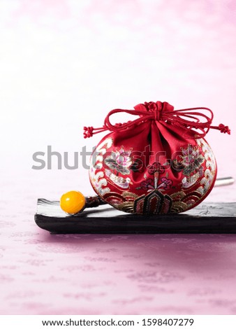Korean traditional embroidery bag and bean curd in pale red