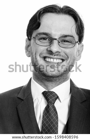 Face of young happy businessman smiling while wearing eyeglasses