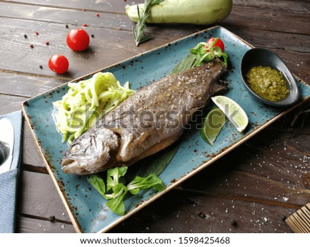 River trout with mashed potatoes and pesto sauce, garnished with Basil and cherry tomatoes.Photos for bar and restaurant menus