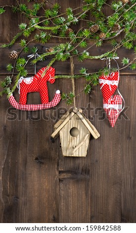 handmade christmas decoration hanging over rustic wooden background. sentimental nostalgic retro style picture