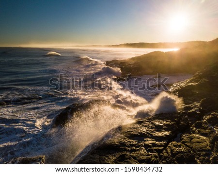 Aerial view crashing waves on rugged shoreline in West Coast of New Zealand during sunrise. Concept: tide, power, fresh, new day, coastline, crush, gist