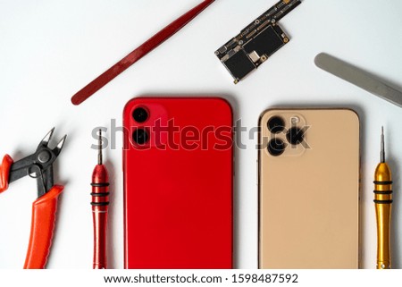 Closeup of two smartphones ready to repair. A close up picture of isolated mobile phone getting ready to repair.