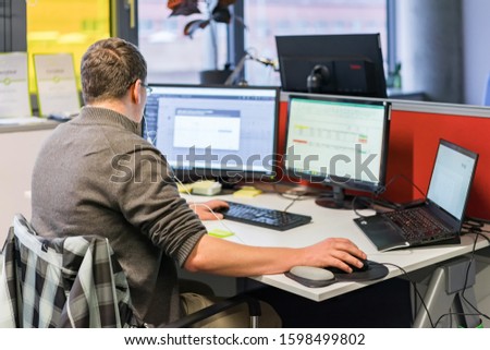 Man sitting on chair and working on computer.
