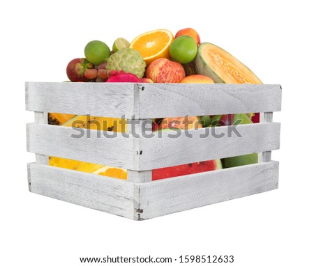 Fruits in wooden box isolated on white