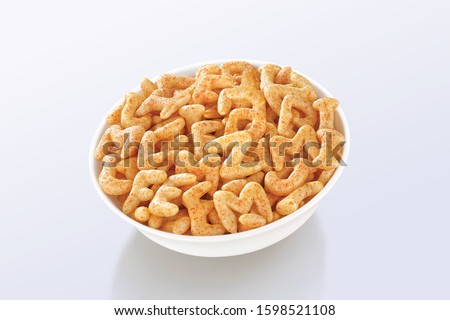 Fried and Spicy ABCD, Alphabet Snacks or Fryums (Snacks Pellets) served in a white bowl. selective focus - Image Royalty-Free Stock Photo #1598521108