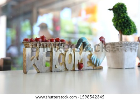 sign board carving from wooden with welcome word and chicke use for decoration