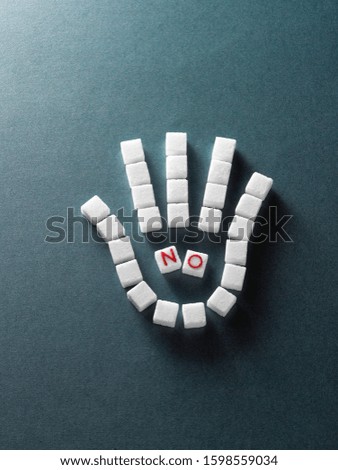 The concept of hand-shaped no sugar with white sugar in dark background