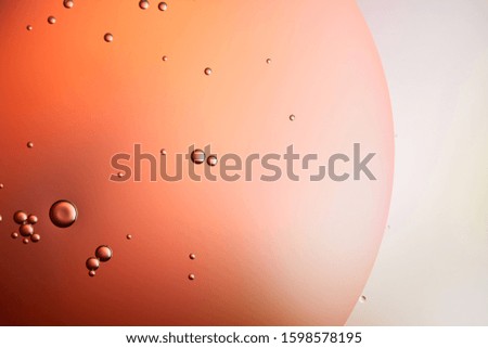abstract background from mixed water and oil bubbles in red and grey color