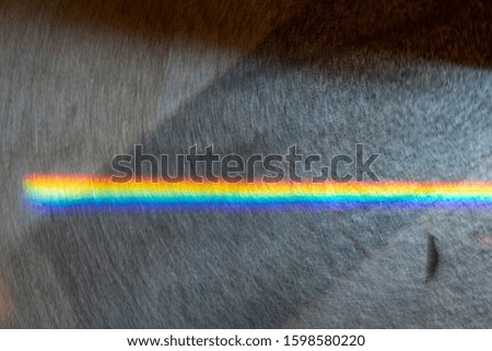 Minimalist composition of small spectrum from glass reflex to texture on floor. Close up macro photo can show how beautiful of rainbow glare spectrum that look science and interesting to learning.