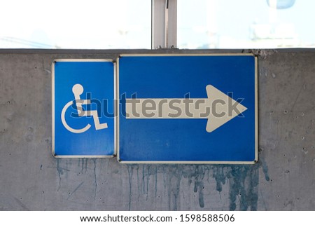 handicap symbol on concrete wall.