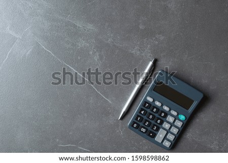 Close up of black calculator with pen and copy space. Technology and financial concept.