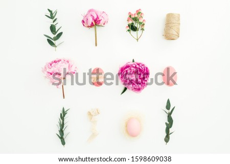 Ester holiday composition with eggs, pink peonies and eucalyptus branches on white background. Flat lay, top view