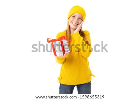 Little caucasian girl holds a white box with gift and has a lot of emotions isolated on white background