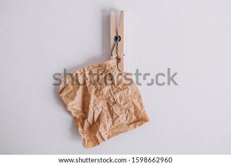 Brown sticker with wooden clothespin isolated on white background. Place for your text