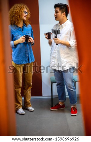 Full length of two colleagues standing together and talking stock photo