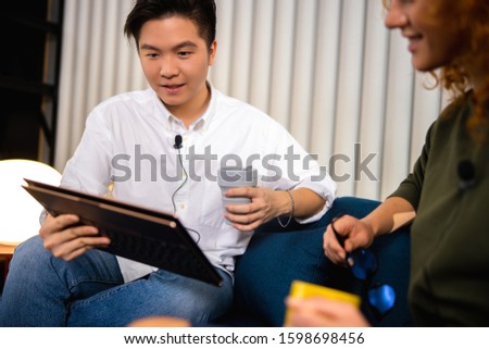 Two employees recording vlog in office stock photo