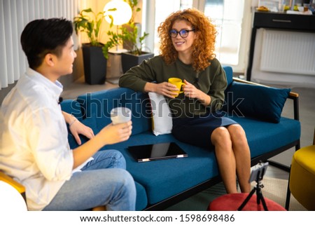 Smiling Asian man on interview indoors stock photo