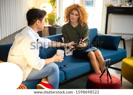 Curly lady taking interview in office stock photo