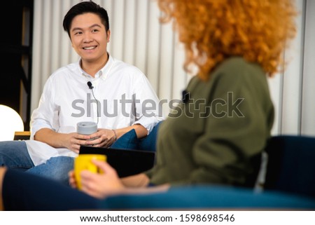 Smiling Asian guy during the interview stock photo