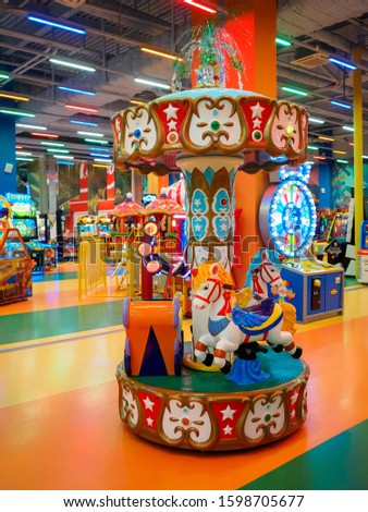 Children's carousel with horses in the playroom.