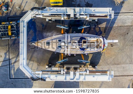a sailing yacht on a travel lift Royalty-Free Stock Photo #1598727835