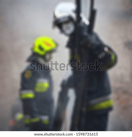 Blurred abstract background of fireman on duty with their colored uniform
