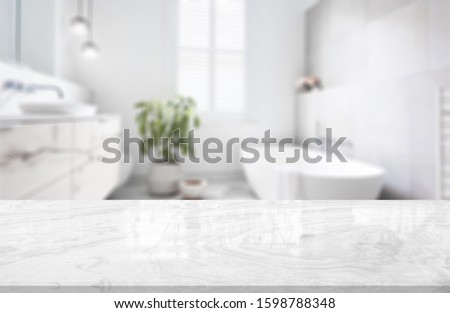 Table Top And Blur Bathroom Of The Background Royalty-Free Stock Photo #1598788348