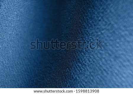 The texture of the fabric closeup, macro photo. Trend color 2020 Classic blue. Spectacular background abstract image.